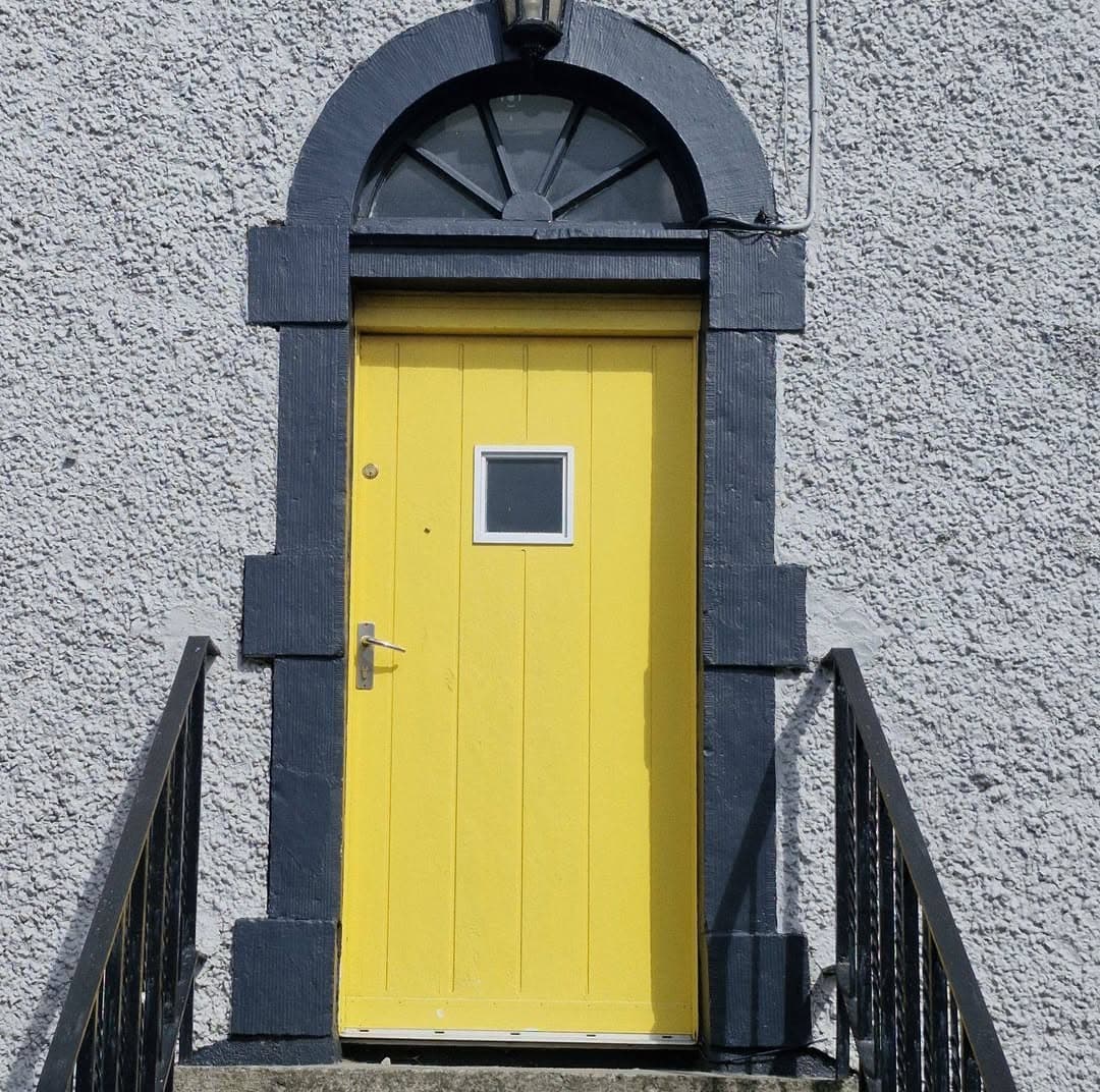 The yellow front door entrance to Edenderry Central Rooms